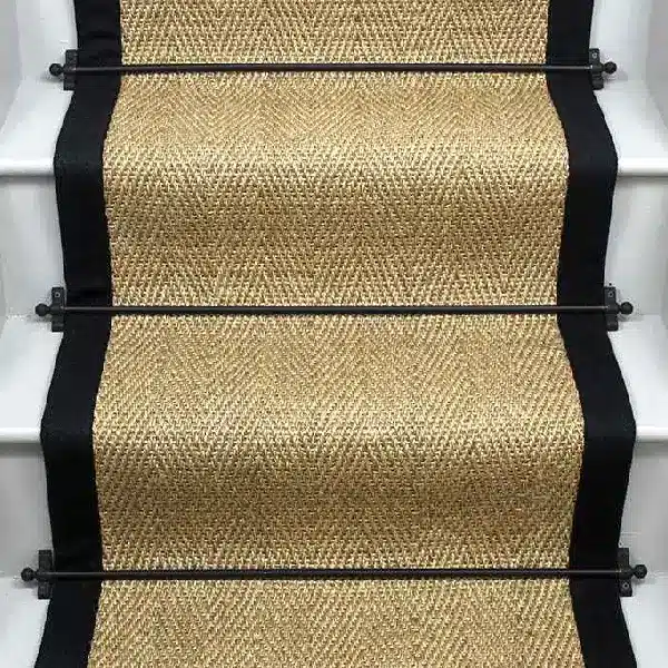 Honey Herringbone Sisal Stair Runner with a black border.