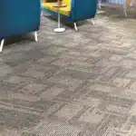 Modern linear patterned carpet tiles for office lounge and commercial seating areas in Dubai.