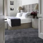 Premium dark grey carpet rolls for luxury bedroom flooring in Dubai.