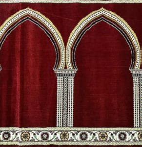 Soft red mosque carpet in Dubai with elegant white and gold arch patterns for masjid prayer hall flooring.
