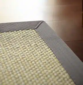 cream sisal carpet with a grey cotton border for luxury home flooring and modern villa interiors in Dubai.