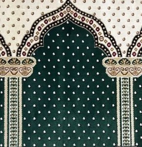 green Firdaus Masjid carpet in Dubai with intricate cream arch patterns and floral accents for mosque prayer halls.
