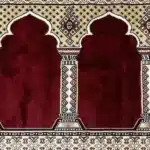 red mosque carpet in Dubai with traditional Mihrab patterns for masjid prayer halls and Islamic centers.