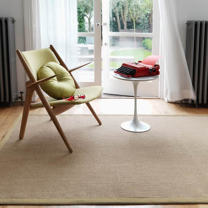 Cream basketweave sisal rug with a dark border