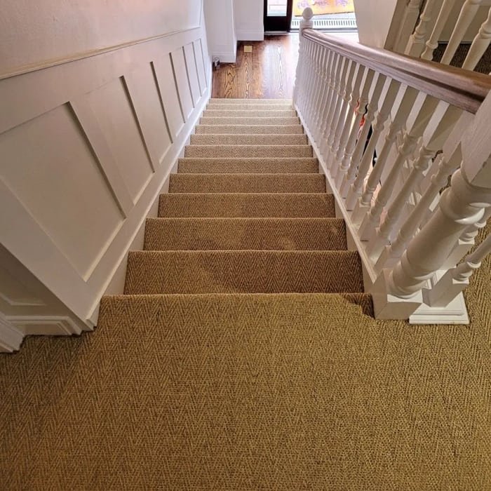 Herringbone patterned sisal runner carpet on stairs