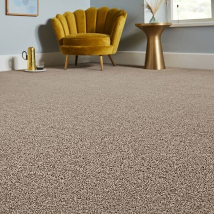 Light brown saxony carpet near a yellow chair