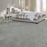 Light-gray-carpet-in-bright-bedroom-with-checkered-bedding