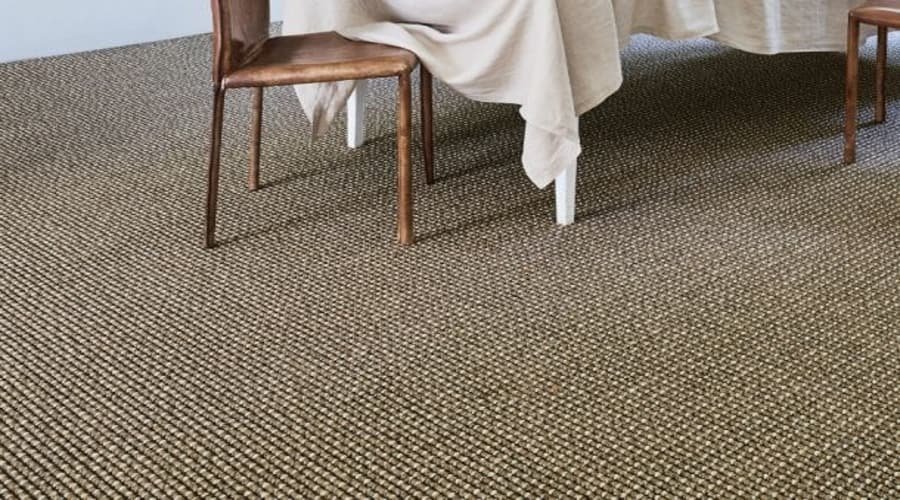 Sage green sisal carpet under a wooden dining set