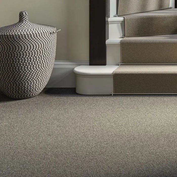 Textured grey loop pile wall to wall carpet near a staircase